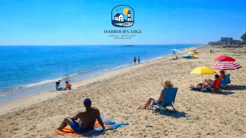 Harbour's Edge Laaiplek Beach with people enjoying the coastal lifestyle.